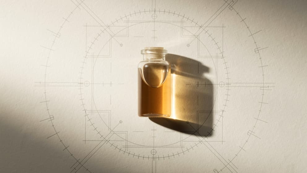 Top-down still-life of a closed laboratory vial with pale amber liquid on an architectural calibration blueprint with unmarked tick marks